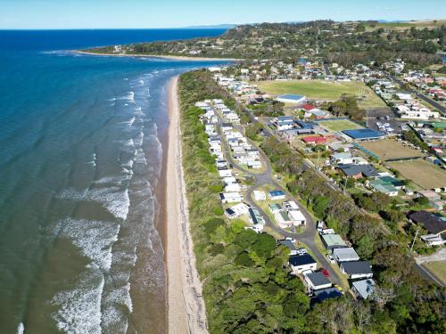 an aerial view of a beach with houses and the ocean at Turners Beach Holiday Cabin in Turners Beach