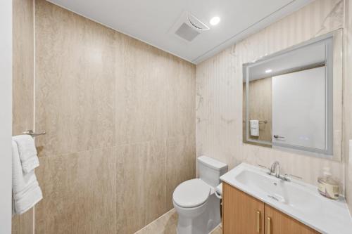 a bathroom with a toilet and a sink and a mirror at The Black Nut NYC in New York