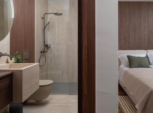 a bathroom with a shower and a bed and a sink at Luxury villa Zara, first row to the sea! in Kali