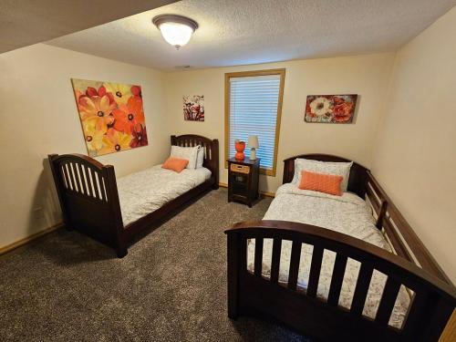 a bedroom with two beds and a window at The American Carriage House in Liberty