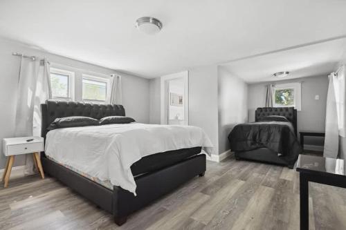 a bedroom with a large bed and a chair at 4BR Niagara Falls Home Free Parking WiFi in Niagara Falls