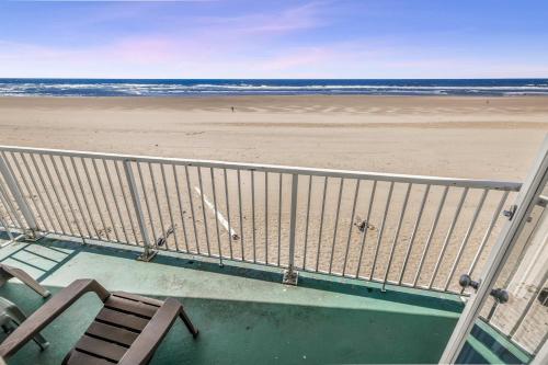 a view of the beach from the balcony of a beach house at Ground Floor Fireplace Studio - Ocean View & Beach Access - Pool and Hot Tub in Lincoln City