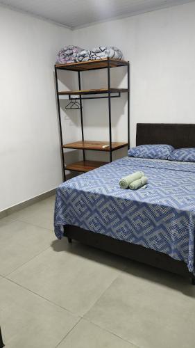 a bedroom with a bed and a book shelf at Apartamento Bela Vista in Canoinhas