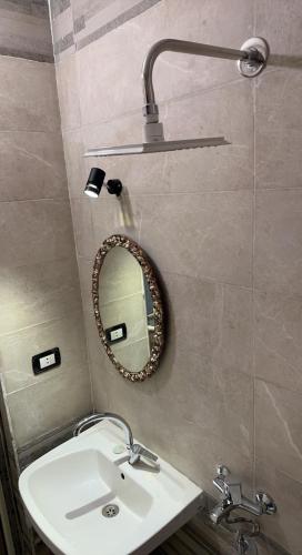 a bathroom with a sink and a mirror on the wall at camp caesar in Dahab