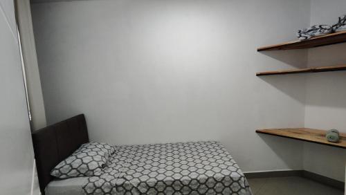 a small bedroom with a bed in a room at Apartamento Bela Vista in Canoinhas