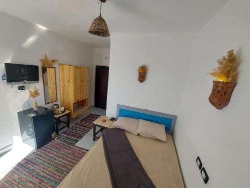 a room with a bed and a tv in it at camp caesar in Dahab