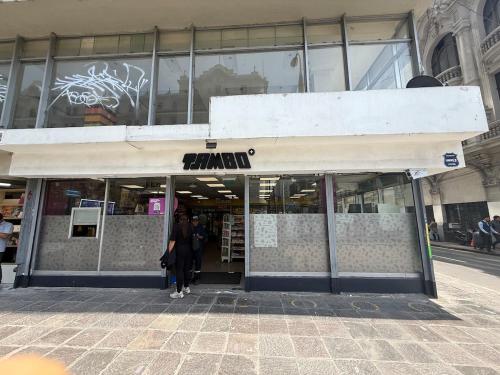 a woman standing in the doorway of a store at Apartment in Lima's historic center in Lima