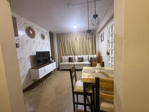 a living room with a dining room table and a couch at Apartment in Lima's historic center in Lima