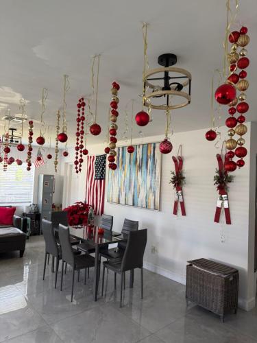 a dining room with a table and chairs and christmas decorations at HOSTEL Star in Hallandale Beach