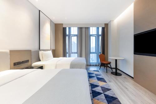 Ένα ή περισσότερα κρεβάτια σε δωμάτιο στο Wanda Moments Neo, Nanchang West Railway