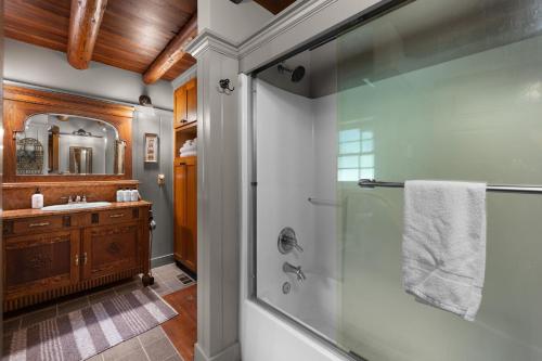 a bathroom with a shower and a sink at Lookout Log Cabin in Rhododendron