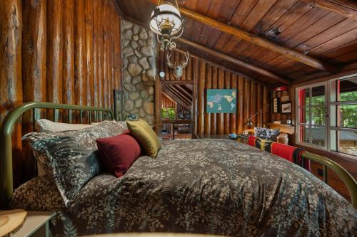 a bedroom with a bed in a room with wooden walls at Lookout Log Cabin in Rhododendron