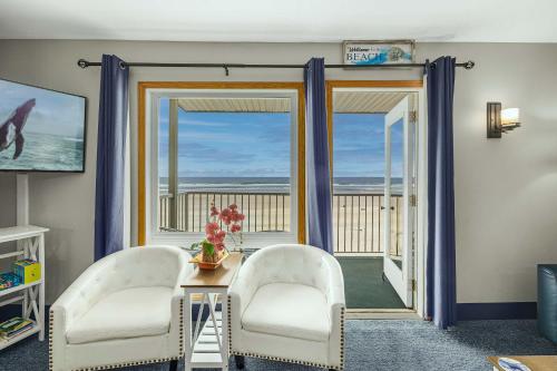 a living room with two chairs and a table at Oceanfront Suite - Sleeps Six - Pool & Hot Tub in Lincoln City