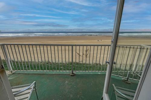 a balcony with a view of the beach at Oceanfront Suite - Sleeps Six - Pool & Hot Tub in Lincoln City