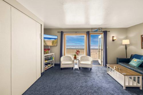 a living room with a couch and a table and chairs at Oceanfront Suite - Sleeps Six - Pool & Hot Tub in Lincoln City