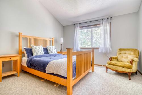 a bedroom with a bed and a chair and a window at Waldport Serenity in Waldport