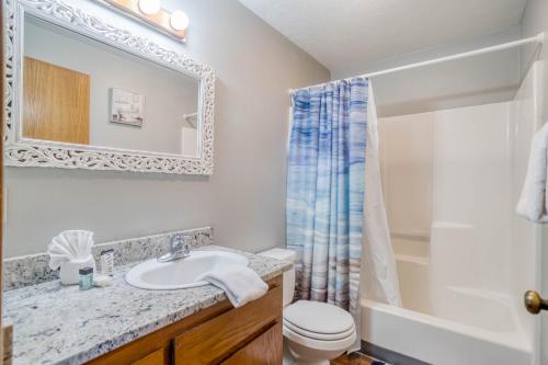 a bathroom with a sink and a toilet and a shower at Waldport Serenity in Waldport