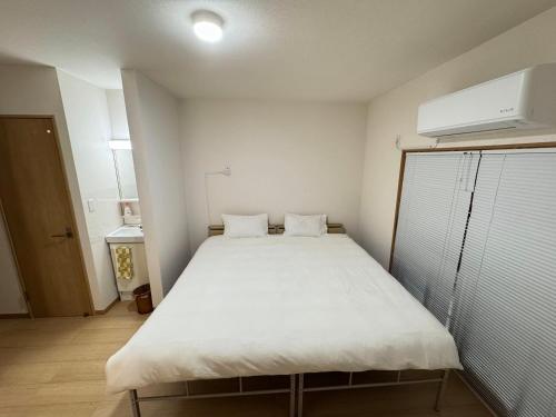 Ένα ή περισσότερα κρεβάτια σε δωμάτιο στο Ippaku 一泊