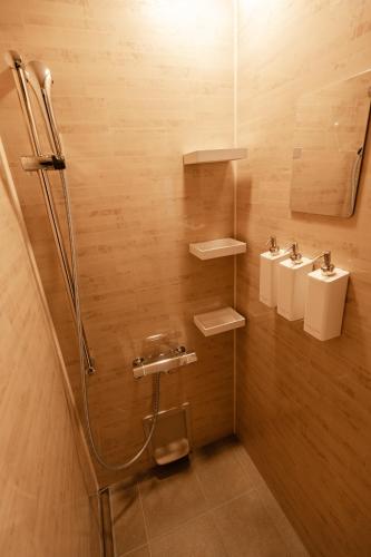 a bathroom with three sinks and two toilets at Snow Horizon in Hakuba