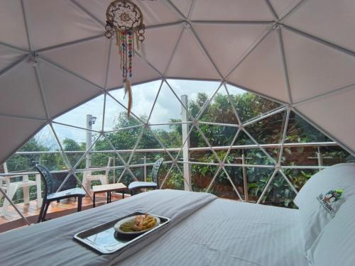 a plate of food on a table in a dome tent at Glamping Morpho Azul Silvania Cundinamarca in Silvania