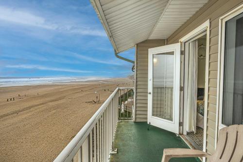 a balcony of a house with a view of the beach at Top Floor Ocean View Suite - Sleeps Six - Pool & Hot Tub Access in Lincoln City