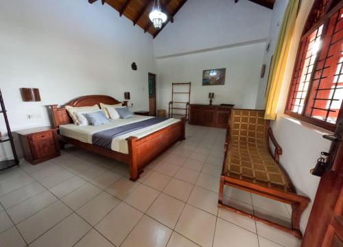 Ένα ή περισσότερα κρεβάτια σε δωμάτιο στο Sanka Rest Ayurvedic Home Stay