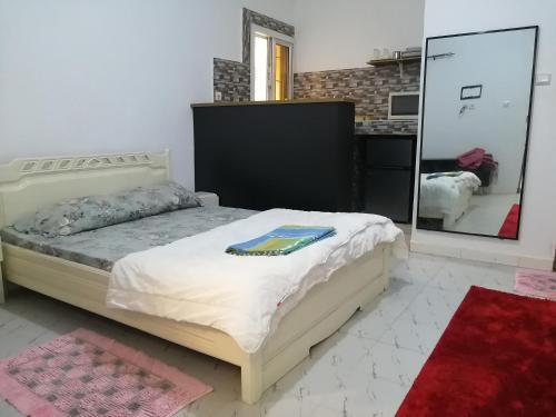 En eller flere senge i et værelse på Résidence hibis chez M&B