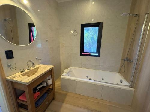 Cabaña La Arianna في سانتا تيريسيتا: حمام مزود بحوض استحمام ومغسلة ومرآة