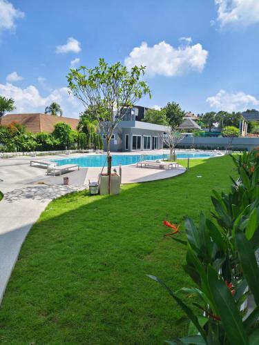 an image of a swimming pool with a park at Babylon Sky Garden 2 in Rawai Beach