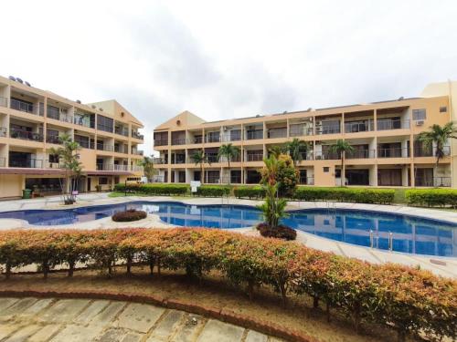 an image of an apartment complex with a swimming pool at Ayu Blue Lagoon PD by GPH in Gua Sai