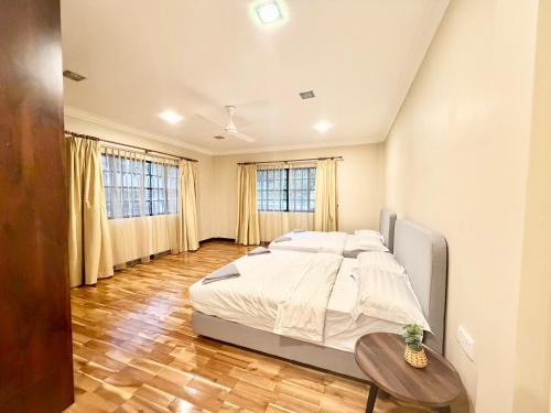 a bedroom with a large bed and a table at Deco Home The Oasis Mesilau at Kundasang in Kundasang