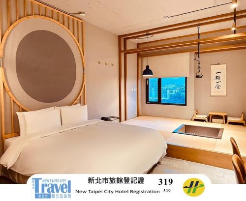 a bedroom with a large white bed and a window at Thinker Hotel in Yingge