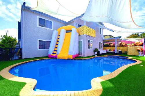 a pool in front of a house with a water slide at Casa de Bloom Venue - Your Perfect Event Space in San Diego