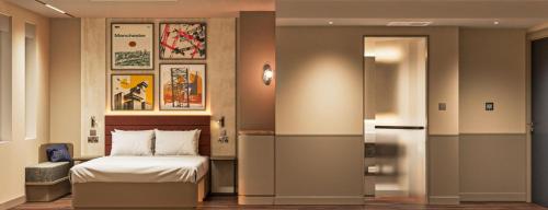 a hotel room with a bed and a sliding door at Hampton By Hilton Manchester City Centre in Manchester