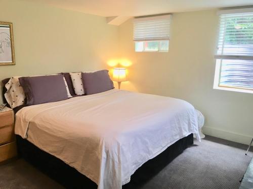 a bedroom with a large white bed in a room at King Suite Between City and Slopes in Denver