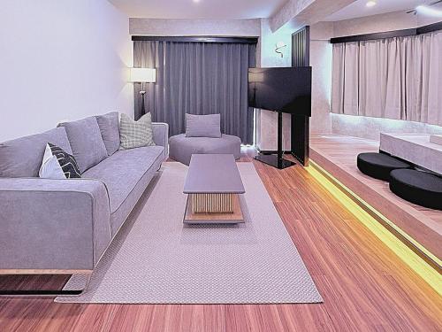 a living room with a couch and a tv at Spacious Family Stay Shinagawa-Kokoro House in Tokyo