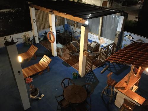 an overhead view of a room with chairs and a table at Penguin Hostel in Puerto Ayora
