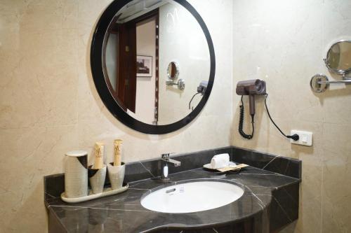 a bathroom with a sink and a mirror at La Nueva Boutique Hotel Hanoi & Spa in Hanoi
