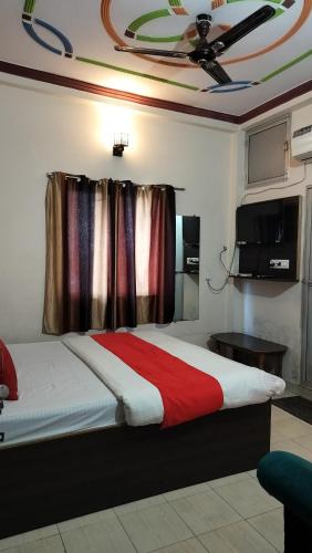 a bedroom with a bed and a ceiling at Bliss Guest House Assi Ghat in Varanasi