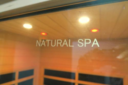 a window with the name of natural spa on it at Hotel Silk no Mori (Adult Only) in Tosu