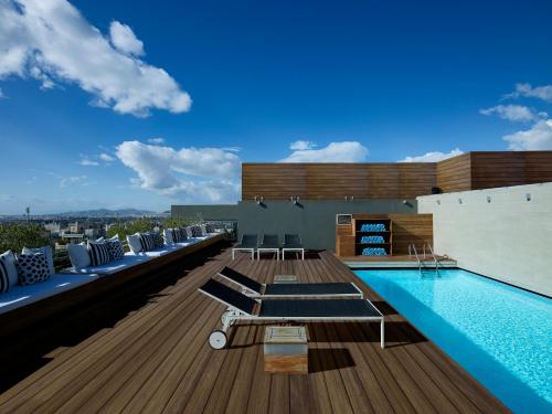 a swimming pool on the roof of a building at Hotel Fresh in Athens