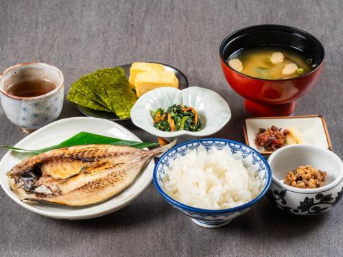 una tavola ricoperta di ciotole di cibo e riso di Matsuura City Hotel a Matsuura