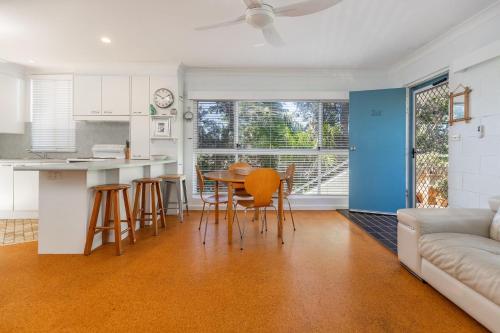 a kitchen and living room with a table and chairs at Blueys Beach Villa Manyana 26 in Blueys Beach