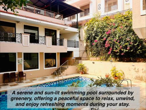 a apartment building with a swimming pool in front of it at Marvella Stays in Anjuna