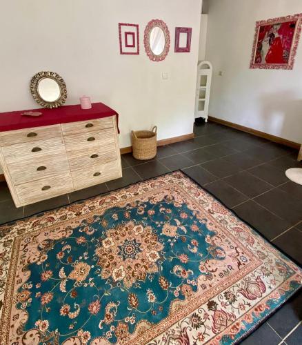 a room with a dresser and a rug on the floor at Whispering Hills in Perean