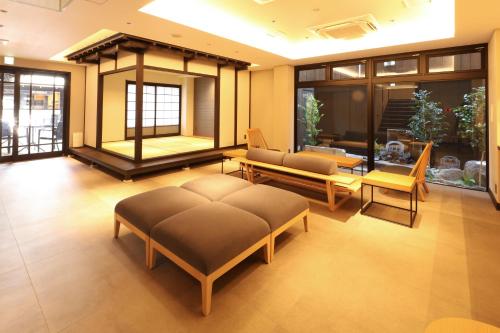 a living room with a couch and a table at HATAGO HIKONE - Annex in Hikone