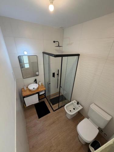 a bathroom with a toilet and a sink at The Marseille Oasis in La Porteña