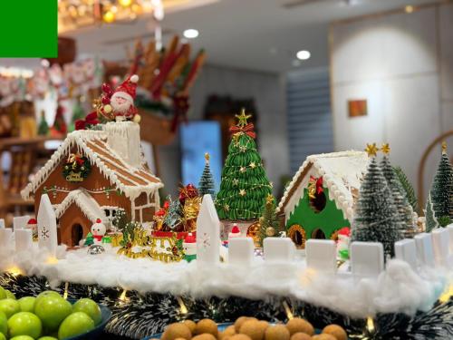a display of christmas gingerbread houses and christmas trees at PHUC LONG LUXURY Danang in Da Nang