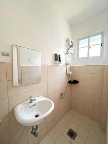 a bathroom with a sink and a mirror at Best Inn - Bohol 1407 in Dauis