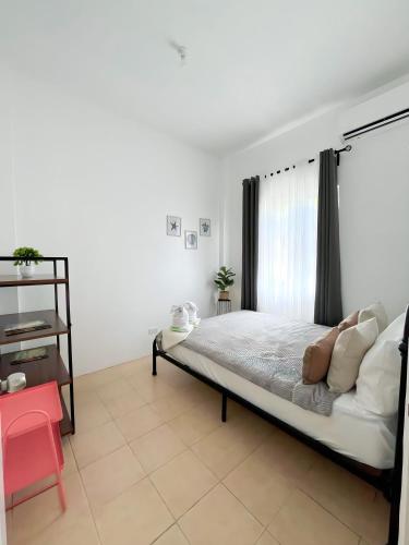 a bedroom with a bed and a window at Best Inn - Bohol 1407 in Dauis